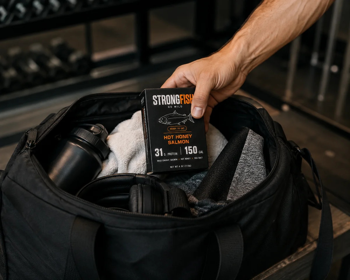STRONGFISH Hot Honey Salmon carton in a gym bag